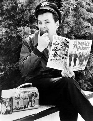 HOGAN'S HEROES, Bob Crane with thermos, lunchbox and comic book all product spinoffs from the show,